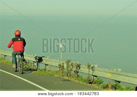 Bikeriding Down  Haleakala Mountain in Mauii, Hawaii with the Ocean in the Background