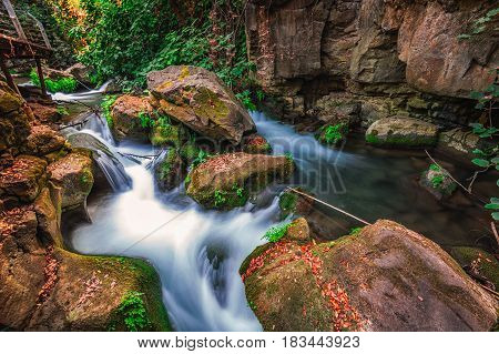 Banias river at north of Israel, flowing over rocks, shot with long exposure technique.