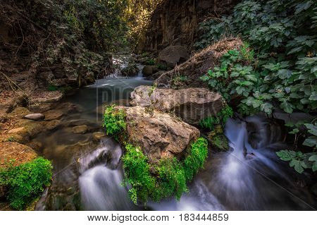 Banias river at north of Israel, flowing over rocks, shot with long exposure technique.