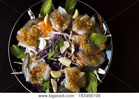 raw prawns with Thai spicy sauce on top.