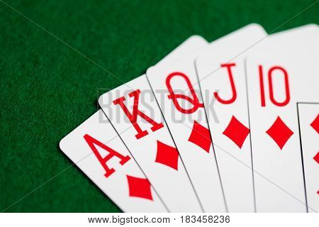 casino, gambling, games of chance, hazard and entertainment concept - royal flush poker hand of playing cards on green cloth