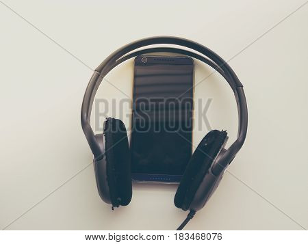 Headphone and Smartphone in Workplace, Isolated Elegance Background
