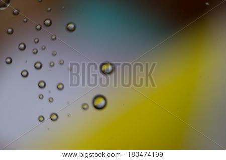 Beautiful drops colorful bokeh blurred defocused dots soft lights background with selective focus.