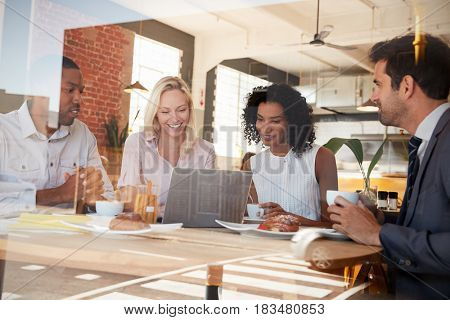 Businesspeople Meeting In Coffee Shop Shot Through Window