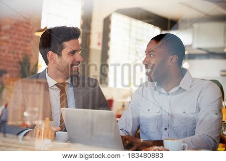 Businessmen Meeting In Coffee Shop Shot Through Window