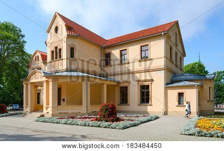 PALANGA LITHUANIA - JULY 12 2015: Unknown people go near Palanga Kurhaus on Alley of Counts of Tyszkiewicz 1 Lithuania