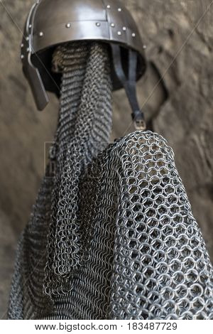 Helmet, chainmail, sword and shields of a medieval armor knight ready for battle