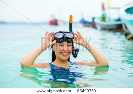 Pretty asian woman wearing underwater snorkling glasses