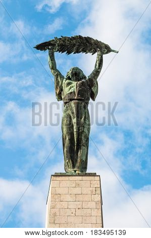 Liberty Statue against the blue sky at sunny day. Monument located on top of Gellert Hill in Budapest, Hungary