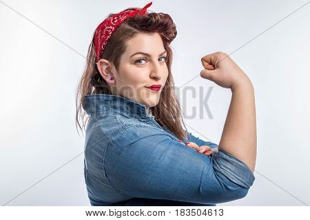 Young plus size pin-up brunette woman like classic We Can Do It poster isolated over white background.