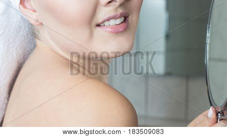 Happy young woman with a white towel on her head. The girl after a shower in a towel.