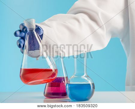 Experiments in a chemistry lab. conducting an experiment in the laboratory with humen hands
