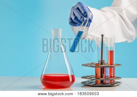 Experiments in a chemistry lab. conducting an experiment in the laboratory with humen hands