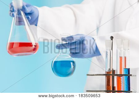 Experiments in a chemistry lab. conducting an experiment in the laboratory with humen hands