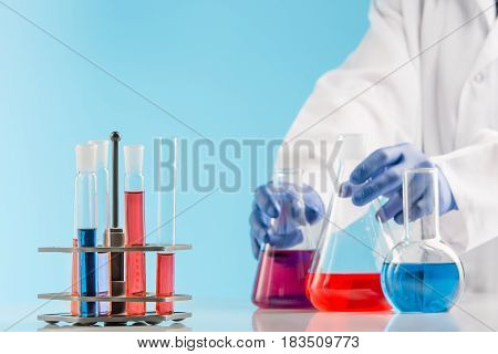 Experiments in a chemistry lab. conducting an experiment in the laboratory with humen hands