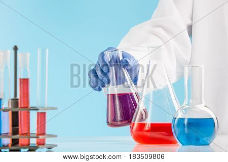 Experiments in a chemistry lab. conducting an experiment in the laboratory with humen hands