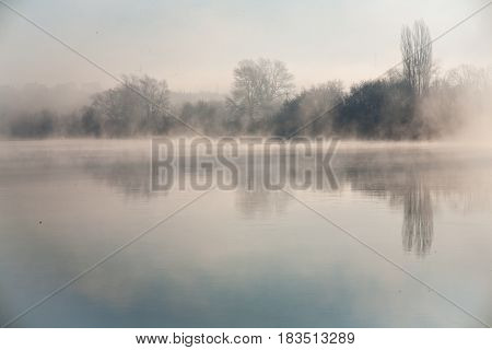 Morning on the river early morning reeds mist fog and water surface on the river