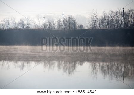 Morning on the river early morning reeds mist fog and water surface on the river