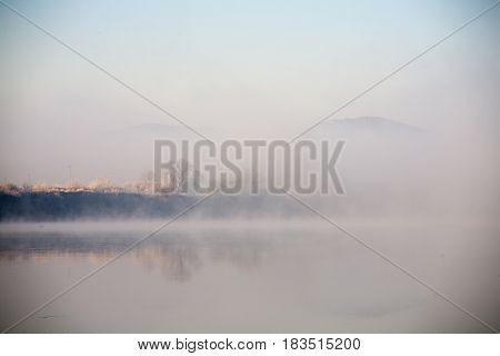 Morning on the river early morning reeds mist fog and water surface on the river