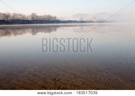 Morning on the river early morning reeds mist fog and water surface on the river