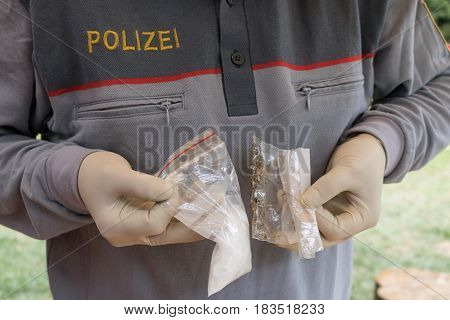 Salzburg Austria - April 16 2017: Lot Of Drugs Seized By  Austrian Police On Table With Weapons