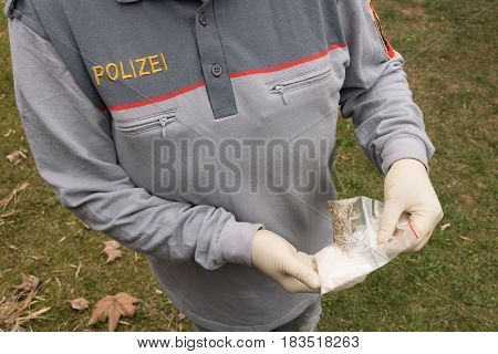 Salzburg Austria - April 16 2017: Lot Of Drugs Seized By  Austrian Police On Table With Weapons