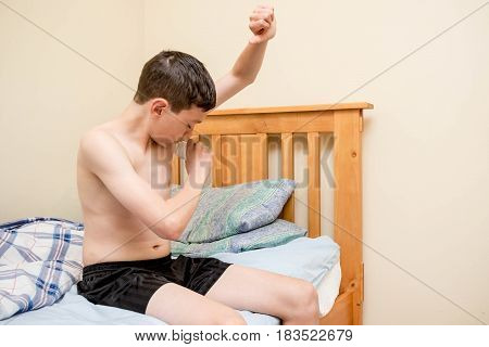 Young caucasian teenage boy using antiperspirant in the morning