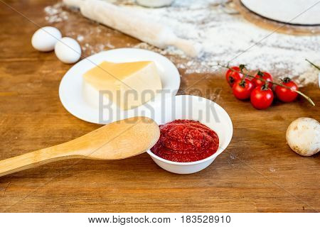 Different Pizza Ingredients, Tomato Paste And Cheese On Wooden Tabletop