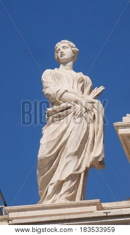 ROME, ITALY - SEPTEMBER 02: St. Thecla, colonnade of St. Peters Basilica. Papal Basilica of St. Peter in Vatican, the world largest church, is the center of Christianity in Rome, on September 02, 2016