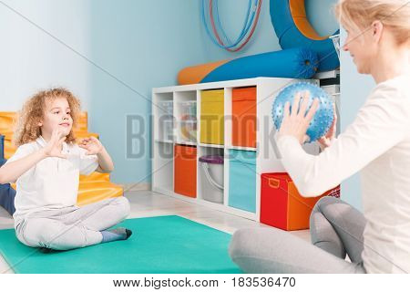 Physhiotherapist Playing Ball With Patient
