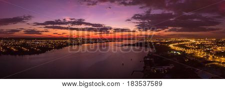  sunrise on a lake over city with lights