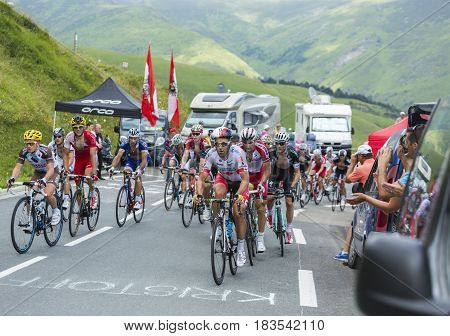 Col de PeyresourdeFrance- July 23 2014: The peloton (gruppetto) climbing the road to Col de Peyresourde in Pyrenees Mountains during the stage 17 of Le Tour de France on 23 July 2014.