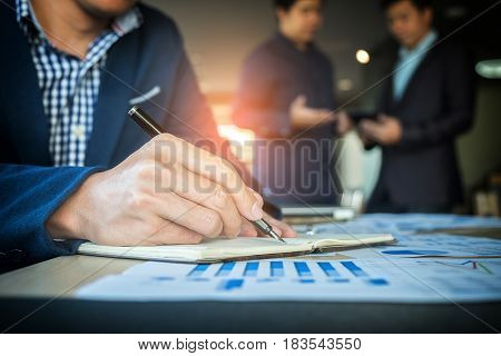 Teamwork process Businessmen hands pointing at document and touchpad during explanation of new plan project data at meeting.