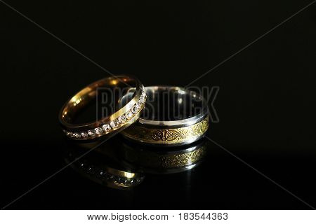 Wedding Rings On A Black Glossy Background