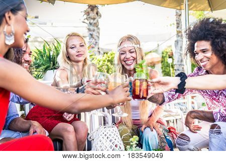 Multiethnic group of friends making party in a lounge bar - Cheerful young adults having fun and celebrating outdoors
