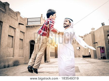 Arabic family playing with child in the old Dubai
