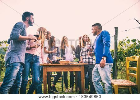 Group of friends at restaurant outdoors - People having dinner in a home garden