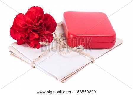 Red carnation with award on old documents on white background
