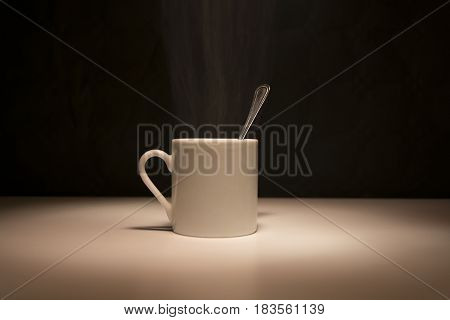 White cup of coffee on black background