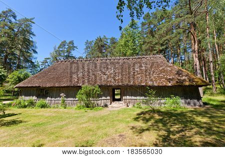 RIGA LATVIA - JUNE 13 2016: Fisherman chimneyless dwelling house (circa 1750s) of Kursi farmstead of Kurzeme ethnic group. Exhibited in Ethnographic Open-Air Museum of Latvia since 1939