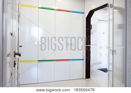 Modern home hallway interior. White plactic panels and tiles. Futuristic interior concept design. Space ship at home
