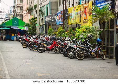 BANGKOK THAILAND - FEB 20 2015: Scooters parked along the street in town. Motorbike is most popular and cheapest transport in Bangkok