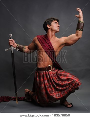 The sexy warrior is crouched down ready for battle.