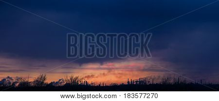 Smog over the industrial city at sunset