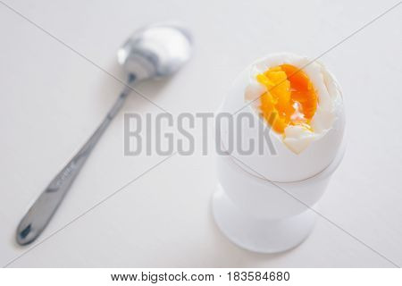 Soft boiled white egg on white background.