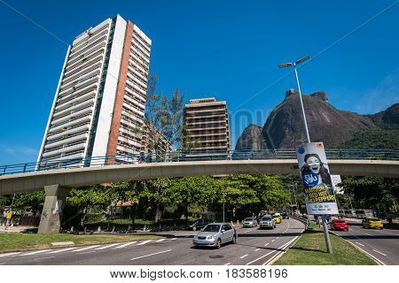 Rio de Janeiro, Brazil - April 6, 2017: Pedestrial bridge over the Lagoa-Barra road in Sao Conrado. The area has beautiful mountain view and is expensive to live in.