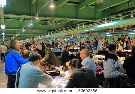 TAIPEI TAIWAN - DECEMBER 3, 2016: Unidentified people visit Jianguo weekend Jade Market. Jianguo Jade Market is a major Jade market in Taipei.