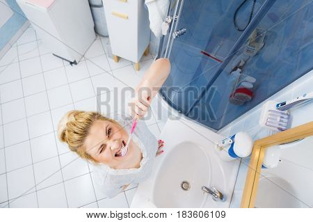 Woman Brushing Cleaning Teeth In Bathroom
