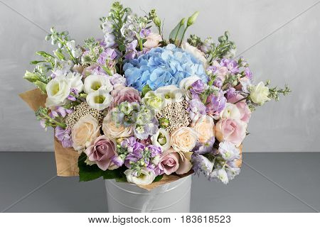 Still life with a bouquet of flowers. the florist put together a beautiful bunch of flowers. Man manual work used different types of flowers and colors.