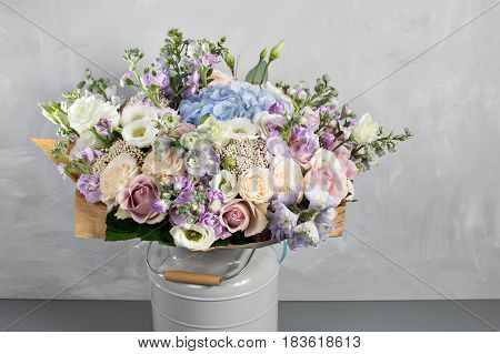 Still life with a bouquet of flowers. the florist put together a beautiful bunch of flowers. Man manual work used different types of flowers and colors.